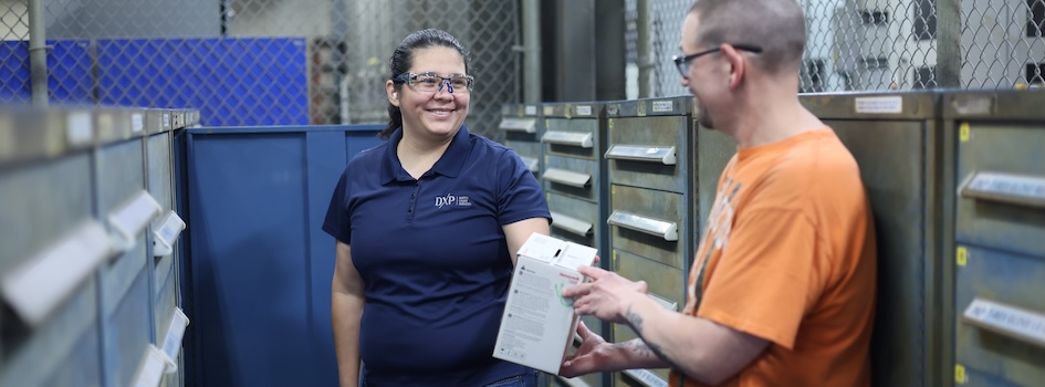 DXP Supply Chain Services attendant using a handheld scanner to issue inventory inside a managed manufacturing tool crib.